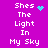 Purple background with white pixelated text reading "Shes The Light In My Sky" and cyan animated symbols changing between heart, starburst, and dot cluster.