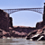 Pixelated landscape with rocky formations under a light blue sky, featuring a horizontal band of lighter pixels across the middle.