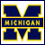 A pixelated blue and yellow logo featuring a large stylized 'M' with a horizontal bar containing the word 'MICHIGAN' in blocky yellow letters.