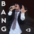 A pixelated figure in a white dress and dark jacket holds hands with another figure against a black background, with vertical text reading "BANG" on the left.