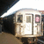 A subway train front with a pink symbol on the right window, viewed from below under bright overhead lights.