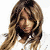 A 50x50 pixel animated contact sheet showing three sequential frames of a woman with long wavy brown hair wearing a white top, displayed in a 2x2 grid layout with one empty gray cell.