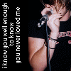 A person in a black shirt holds a microphone near their mouth, with text reading "i know you well enough to know you never loved me" on the left side of the image.