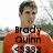 Pixelated image of a person in an orange sports jersey with white accents, standing against a blurred outdoor background.