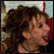 Two side-by-side pixelated images of a person with curly dark hair, showing different facial expressions and slight head positions.
