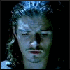 A six- shows a person with long wavy hair and mustache in sequential facial expressions against dark background
