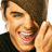 Pixelated image of a person with brown hair smiling broadly, hand near face, next to black background with white text reading 'iac efon'.