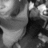 Grayscale pixelated image with abstract light and dark shapes, no discernible subjects or text. The composition features irregular high-contrast areas across the frame.