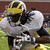 A pixelated image of a football player in a yellow and blue uniform tackling another player, with bold yellow text on a blue background.