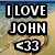 Beach scene with heart-shaped sand drawing and text overlay reading "I LOVE JOHN <33" on a pixelated background.