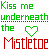 Animated pixel art displays repeating text 'Kiss me underneath the Mistletoe' with a heart symbol cycling through green outline, red fill, and mixed states.