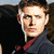 A pixelated image of a person in a dark jacket with a red collar, showing two states: one with a white streak on the face and another with text overlay.