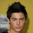 A pixelated image of a person with dark hair against a yellow background, with text overlay reading "Zac Is A Hottie" in white block letters.