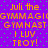 Purple background with green dots and orange text reading "Juli the GYMMAGIGYMMAGI GYMNAST GYMNAST I LUV TROY!" repeated twice in a