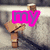 A pixelated image of a wooden figure with arms raised, overlaid by colored text blocks in pink, green, and red.