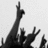 Black and white pixelated image of multiple raised hands against a light background, with one hand prominently extended upward.