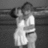 Black-and-white grayscale image of a person in a white dress holding a child, next to pink background with "Live Laugh Love" text.