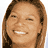 Pixelated image of a smiling person with long brown hair next to pink text reading "Beauty Shop" on white background.