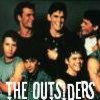 Group of seven people in a posed photograph with text 'THE OUTSIDERS' at the bottom, rendered in low-resolution pixelated style.