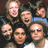A static image with a bright green background, featuring a group photo of six people on the left and blue pixelated text on the right.