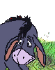 Pixelated cartoon donkey with dark blue-gray body, light brown ears, and pink nose against green grass background.