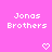 Pixelated pink background with repeated white text "Jonas Brothers" and heart symbols in a
