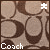 Pixelated image of a brown wooden floor with two large circular indentations and the word 'Coach' in white text at bottom left.