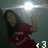 A pixelated figure in dark clothing holds a glowing object against a gradient background with bright light source.