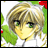 Pixelated anime-style character with blonde hair and green eyes, wearing white clothing against a green and red background with text reading 'Anime IM' and 'COM' on black.