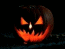 Three identical pumpkin faces with glowing orange eyes and mouths against a dark background, arranged horizontally.