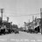 Black-and-white pixelated image of a building with multiple vertical structures and horizontal lines, appearing as a low-resolution architectural scene.