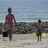 A pixelated beach scene shows two figures walking on sand with a rocky shoreline and blue sky in the background, next to blue pixelated text reading "Brother And Sisterly Love <3".