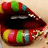 Pixelated close-up of stylized lips with dark interior, multicolored segmented outer edges, and scattered light-colored pixels on a beige background.