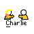 Pixel art buddy icon of a character named Charlie with yellow hair, orange shirt, and white circular head, holding green object while emitting green particle effects.