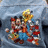 Pixelated image of cartoon characters on a blue background with overlaid text in red and purple.