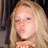 Pixelated image of a person with long blonde hair blowing a kiss, accompanied by text and heart symbols on black background.