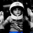 Pixelated grayscale image of a person in an astronaut suit with blue lower torso, set against black background.