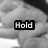 Black-and-white image of a person's face with three text overlays: 'Hold', 'my', and 'Hand' in separate