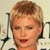 Static pixelated image of a person with short light brown hair, closed eyes, and a neutral expression against a light background with partial dark shapes.