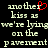 Pixelated text reads 'another kiss as we're lying on the pavement' with a red heart symbol replacing the letter 'o' in 'another', displayed against black background.
