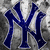 four distinct images: a blue NY logo on gray, a soccer ball, a person with hands behind head, and empty space