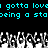 Pixelated cyan text reads 'gotta lova gotta love being a staceing a sta' above a grayscale crowd of raised hands on black background
