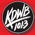 Red background with black circular logo reading 'KOWB 101.3' and white text 'AVRIL LAVIGNE', below a pixelated image of a woman with long brown hair.