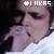 A person in a white shirt holds their hand near their mouth, with text reading 'LUKAS' above the head.