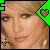 Pixelated static icon showing a person's face with green geometric shapes on the left and right edges, set against a dark background.