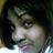 Pixelated close-up of a person's face with dark hair, light skin tone, and visible eye details including eyelashes and iris color.
