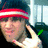 A person wearing a red and white striped headband and dark clothing makes a hand gesture near their face in a of four