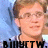 Pixelated portrait of a person with light brown hair and glasses against a blue background, with partial text at the bottom.
