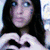 A person with long dark hair forms a heart shape with their hands in three distinct color variations of the same pose.