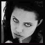 Black-and-white pixelated image of a person's face with dark hair, showing two views: full face and close-up eyes.